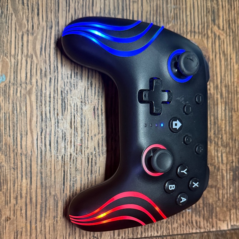 Black and Blue Wireless Game Controller with LED Accents